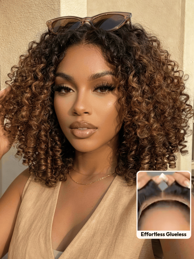 A smiling woman with long, voluminous, curly hair and subtle highlights wears a sleeveless knit top. An inset shows a close-up of her scalp with the realistic hairline of the brown highlight wig labeled ��Invisiknots & Glueless.��.