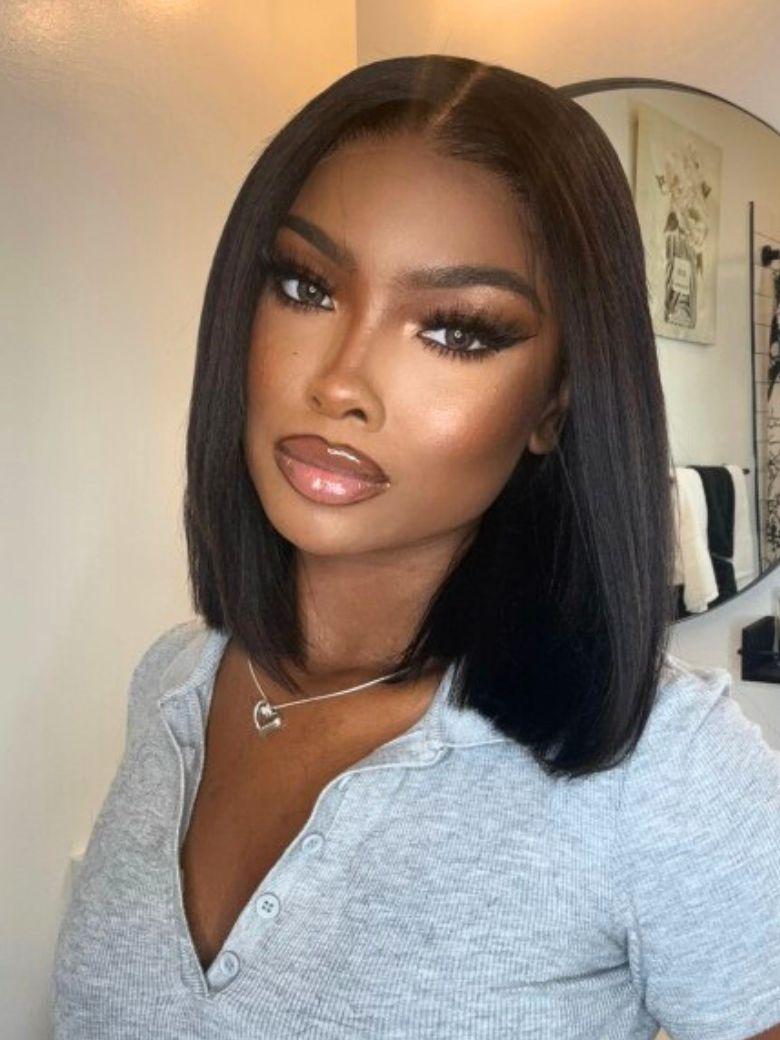 @NauteyaWhyee wearing a sleek yaki straight black human hair bob wig with a precise middle part and natural scalp look.