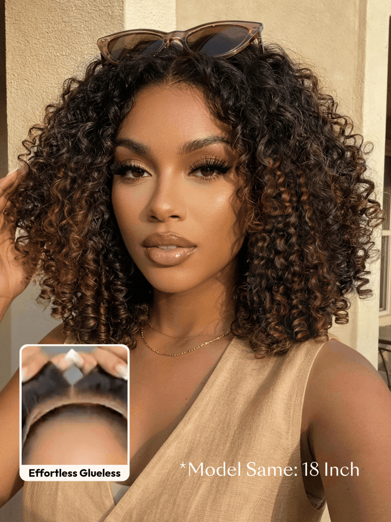 A smiling woman with long, voluminous, curly hair and subtle highlights wears a sleeveless knit top. An inset shows a close-up of her scalp with the realistic hairline of the brown highlight wig labeled ��Invisiknots & Glueless.��.