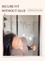 A close-up demonstration of a beginner-friendly secure glueless wig application, showing a pink comb being used to style the pre-plucked hairline and natural middle part of a wavy black wig.